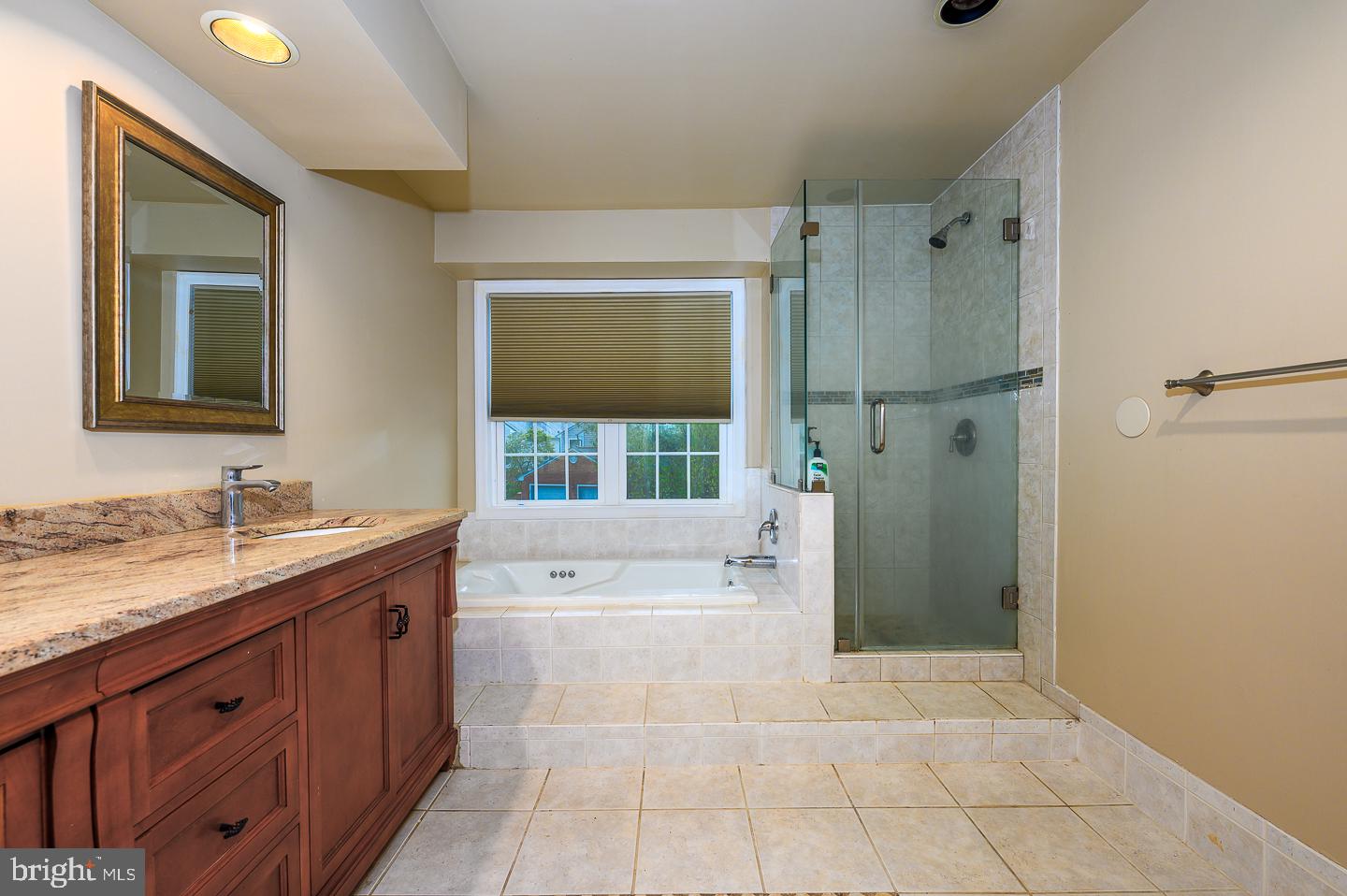 28 Stonebridge Lane Princeton, NJ 08540 - Photo 27 of 34 a spacious bathroom with a granite countertop sink mirror and bathtub