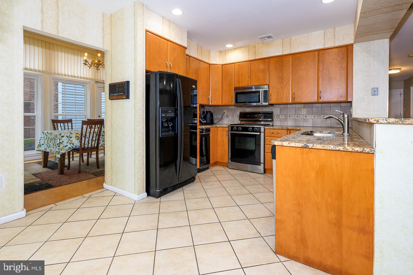 28 Stonebridge Lane Princeton, NJ 08540 - Photo 9 of 34 a kitchen with stainless steel appliances a refrigerator sink and microwave