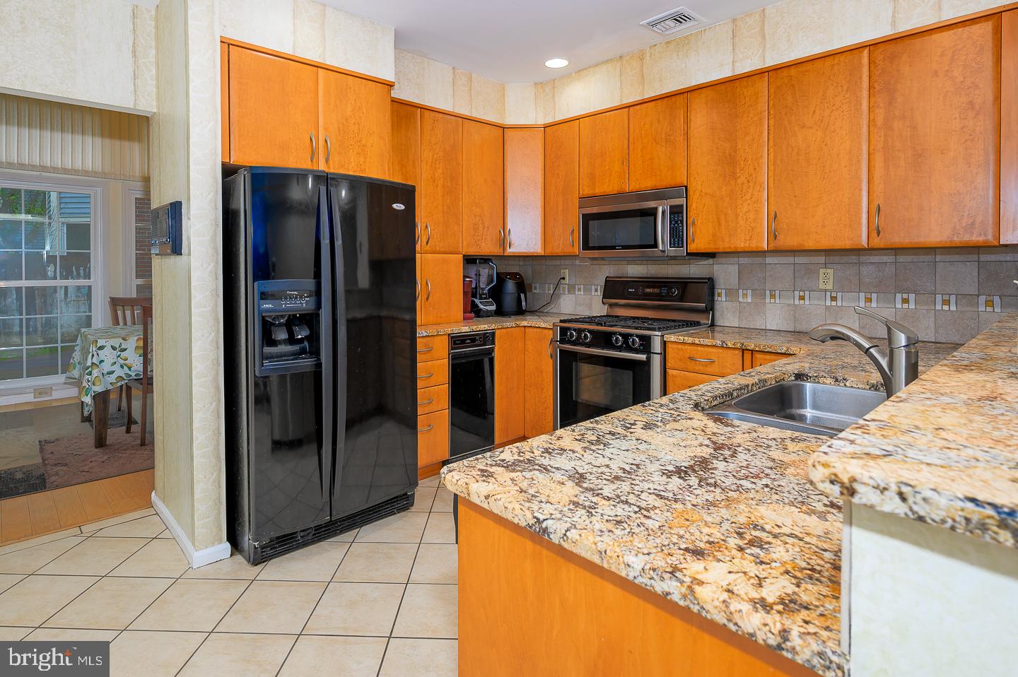28 Stonebridge Lane Princeton, NJ 08540 - Photo 10 of 34 a kitchen with stainless steel appliances granite countertop a refrigerator stove top oven and sink