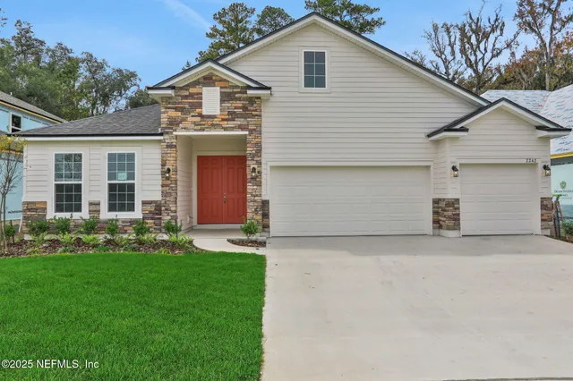 a front view of a house with a yard and garage