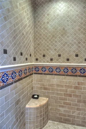 a bathroom with a granite countertop double vanity sink and a mirror