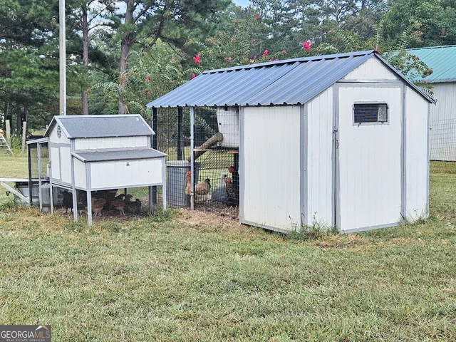 a backyard of a house with table and chairs