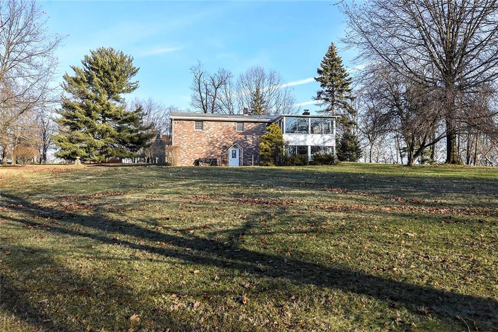 502 Springdale Road Eighty Four, PA 15330 - Photo 2 of 24 The rear view of this property reveals how level and truly usable the acreage is allowing for plenty of space to build on the main home, build another garage, pool etc...