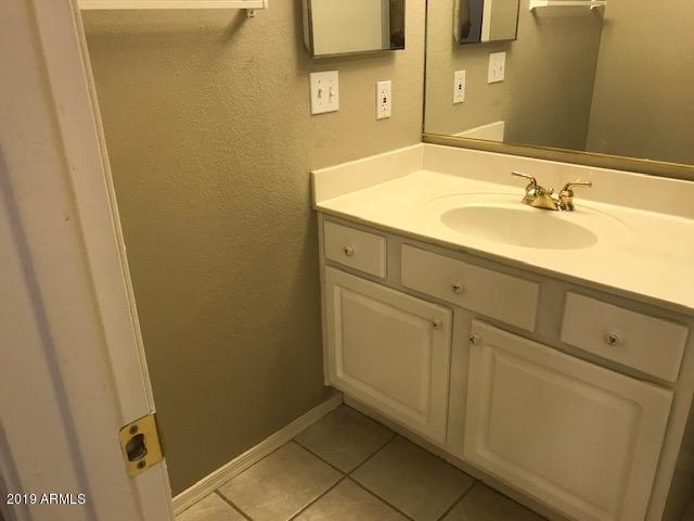 8940 West Olive Avenue, Unit 15 Peoria, AZ 85345 - Photo 5 of 9 a bathroom with a sink and a mirror