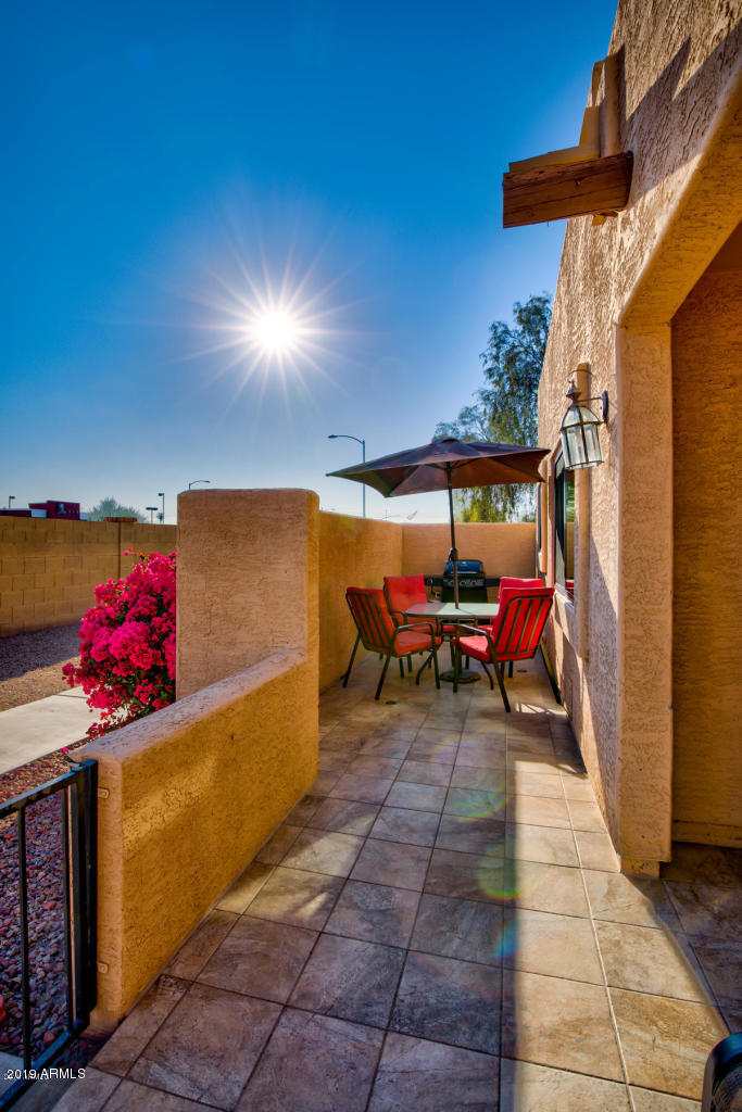 8940 West Olive Avenue, Unit 15 Peoria, AZ 85345 - Photo 8 of 9 a view of a chairs and table in a patio