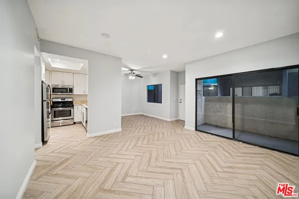 a view of empty room with wooden floor
