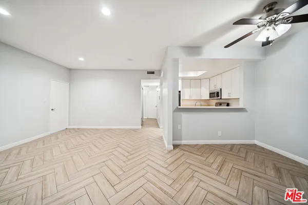 a view of kitchen and empty room