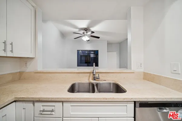 a kitchen with a sink and cabinets
