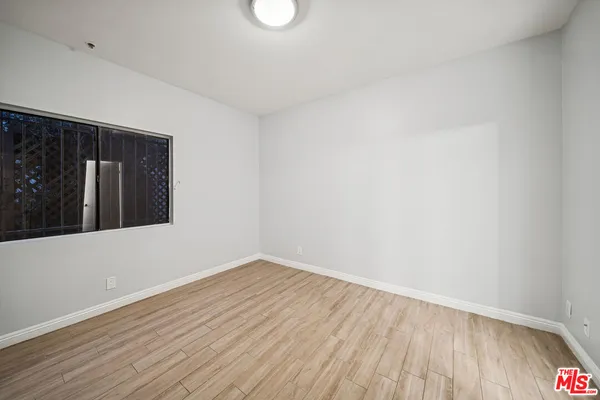 a view of an empty room with wooden floor