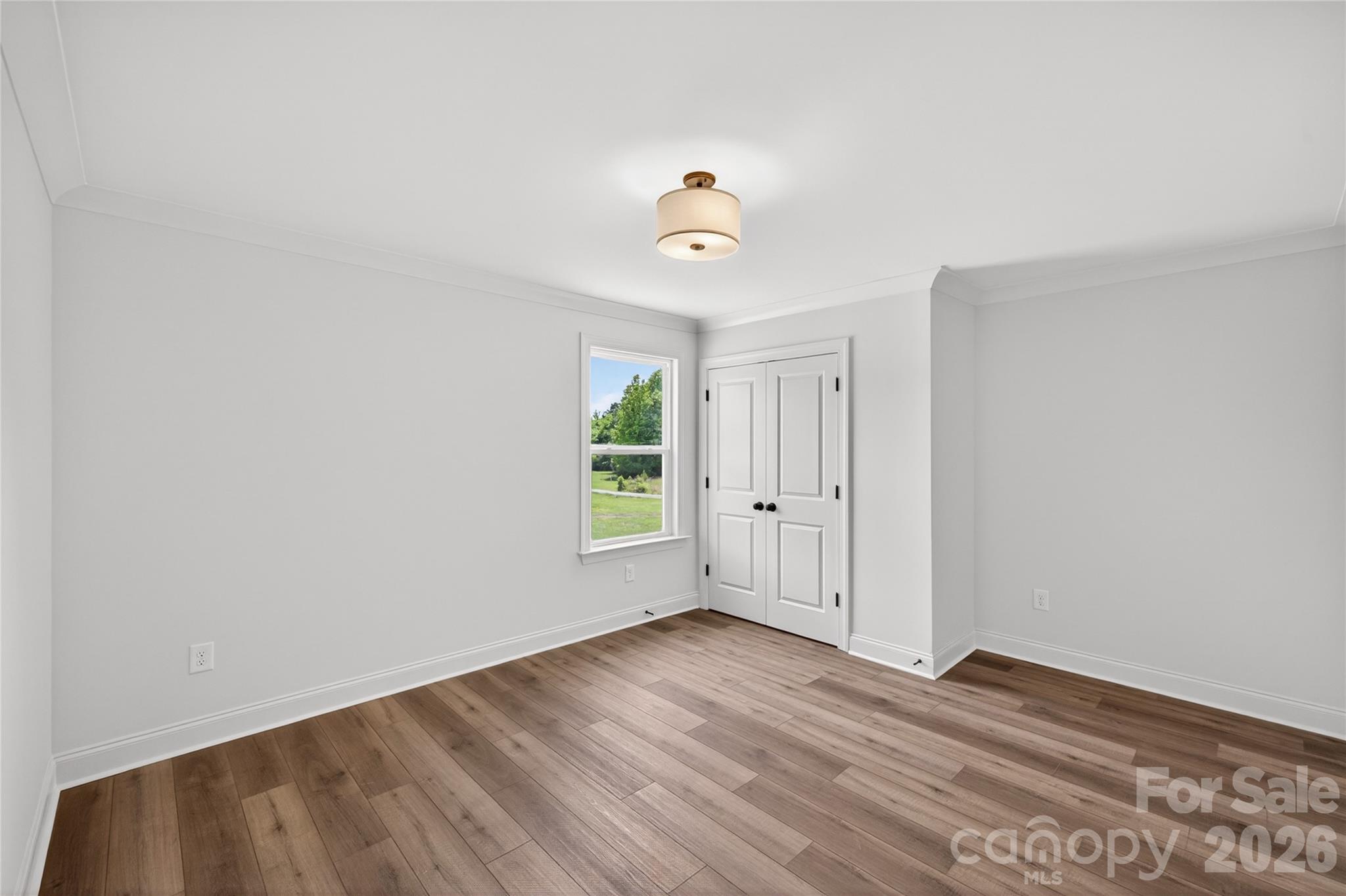 2965 Polk And White Road Charlotte, NC 28269 - Photo 28 of 38 an empty room with wooden floor and windows