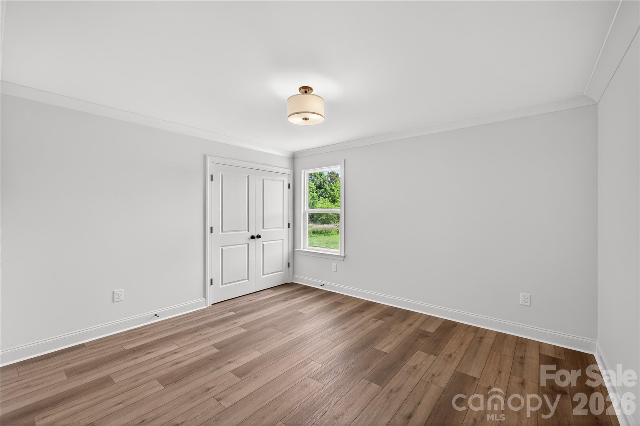 2965 Polk And White Road Charlotte, NC 28269 - Photo 30 of 38 wooden floor in an empty room with a window