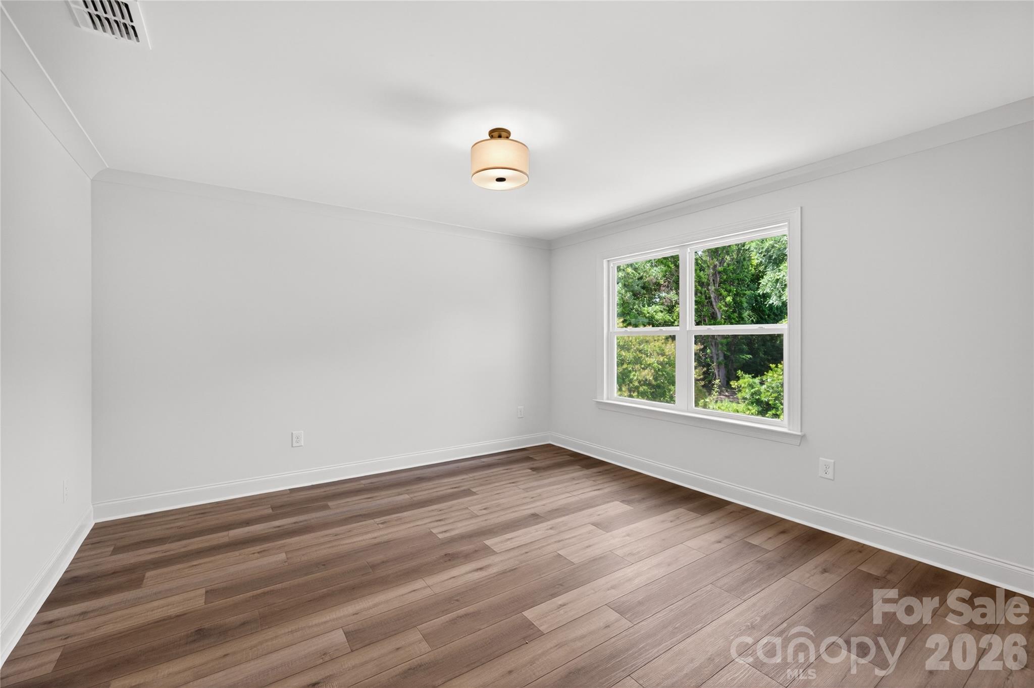 2965 Polk And White Road Charlotte, NC 28269 - Photo 32 of 38 wooden floor in an empty room with a window