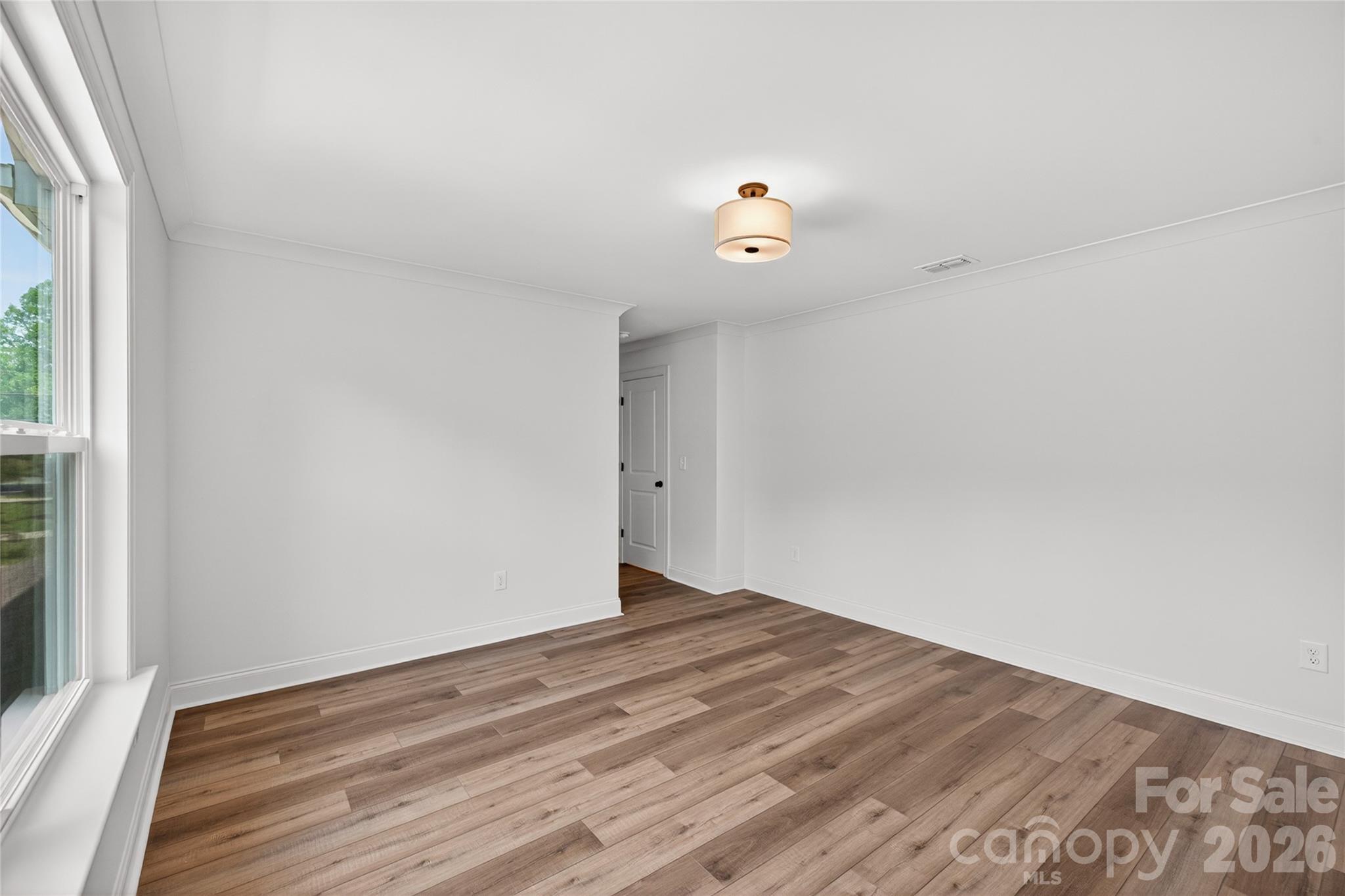 2965 Polk And White Road Charlotte, NC 28269 - Photo 33 of 38 a view of an empty room with wooden floor and a window