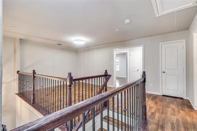 a kitchen with stainless steel appliances kitchen island wooden floors and white cabinets