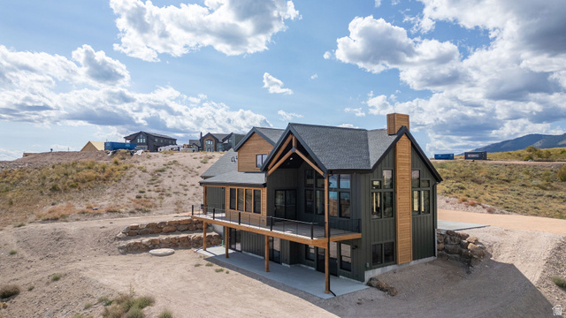 300 Knoll Loop, Unit 227 Fish Haven, ID 83287 - Photo 50 of 56 Rear view of house with a patio, roof with shingles, a chimney, and a mountain view