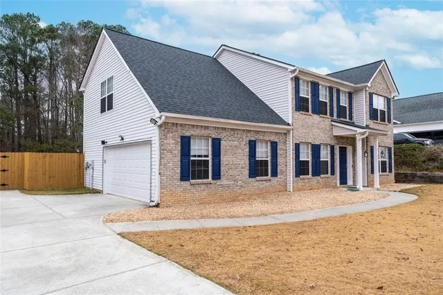 a front view of a house with a yard