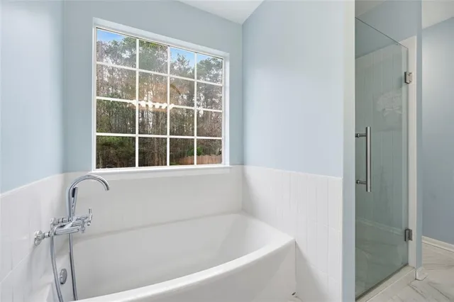 a white bath tub sitting next to a window
