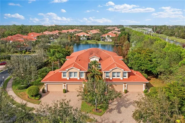 an aerial view of a house with a lake view