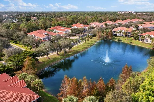 an aerial view of a house with a lake view
