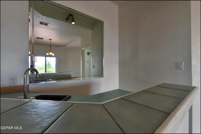 a kitchen with granite countertop a sink and a stove