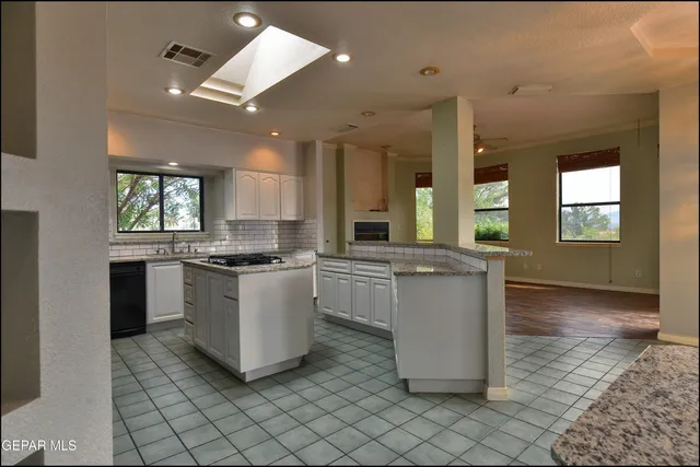 a kitchen with stainless steel appliances granite countertop a sink and a microwave