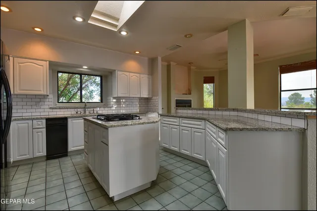 a kitchen with stainless steel appliances granite countertop a refrigerator a sink and a stove