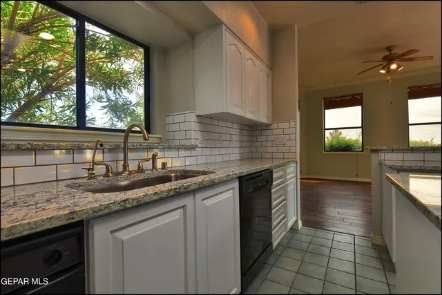 a view of a hallway with wooden floor and a kitchen