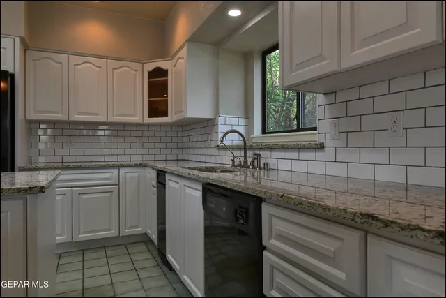 a view of a kitchen with a sink and a fireplace