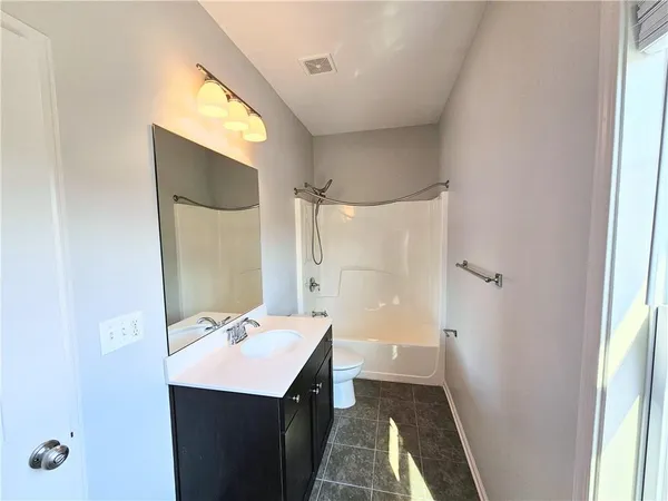a bathroom with a sink a mirror and a toilet