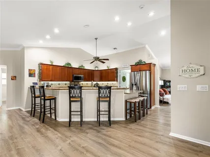 a view of a kitchen with furniture and wooden floor
