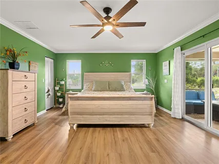 a spacious bedroom with a bed and a dresser