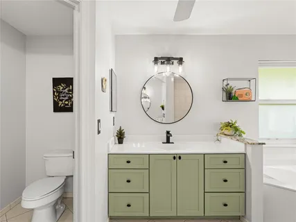 a bathroom with a toilet a sink and a mirror