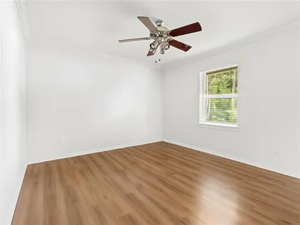 wooden floor in an empty room with a window
