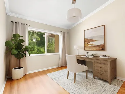 a dining room with furniture and window