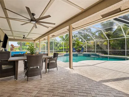 a view of a patio with a table chairs and a floor to ceiling window