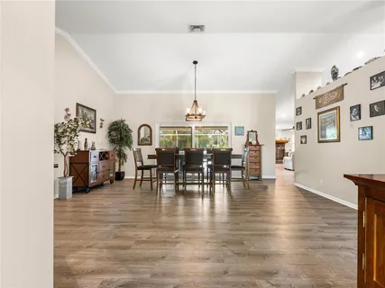 a view of a dining room with furniture and chandelier