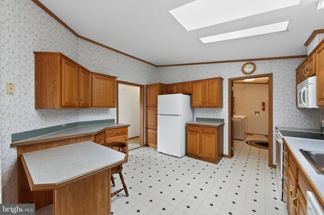 a kitchen with stainless steel appliances a stove microwave and cabinets