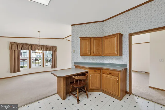 a room with a table chairs and a refrigerator