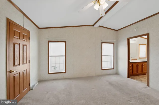 a view of a hallway with wooden floor and glass door