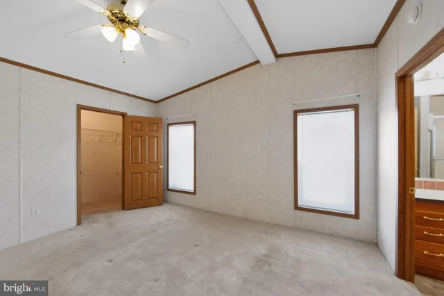 an empty room with windows and cabinet