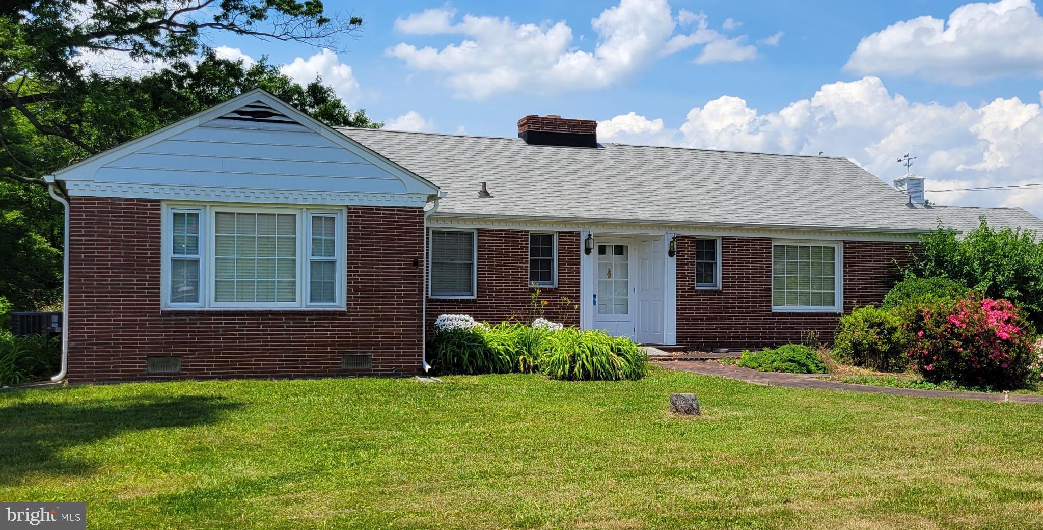9210 Ravenwood Road Rosedale, MD 21237 - Photo 1 of 18 Charming brick home with lush greenery.