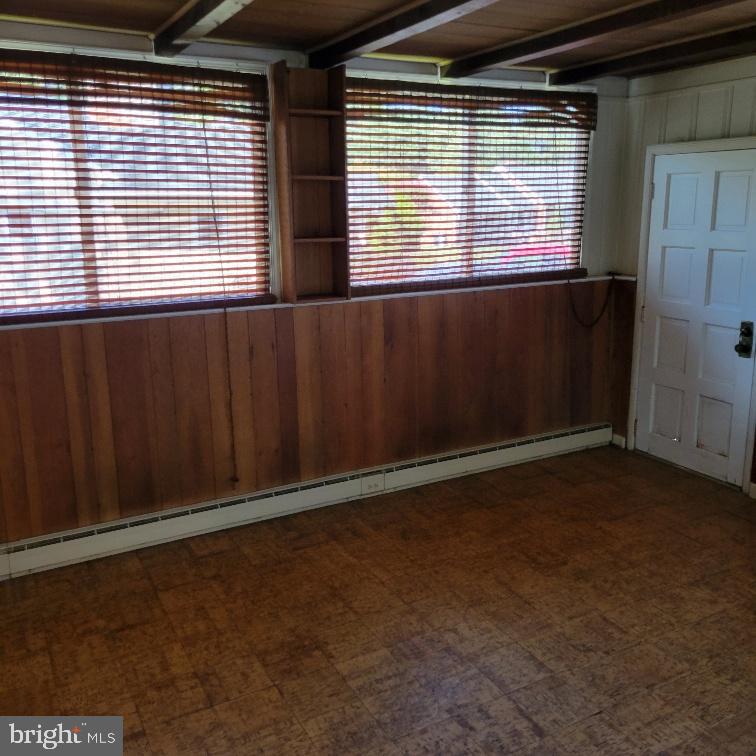 9210 Ravenwood Road Rosedale, MD 21237 - Photo 15 of 18 Sunlit enclosed porch with warm wooden accents.