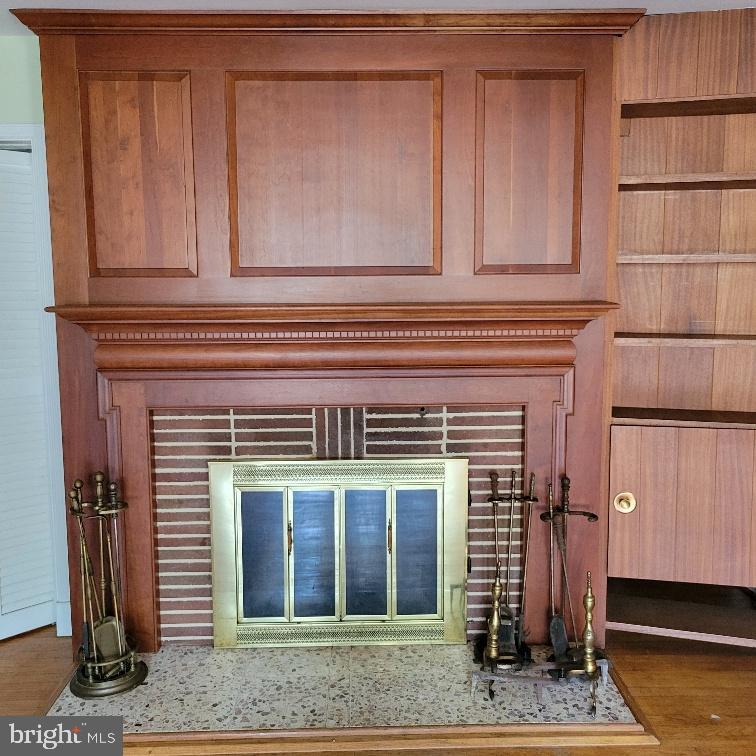 9210 Ravenwood Road Rosedale, MD 21237 - Photo 16 of 18 Elegant wooden fireplace with classic charm.