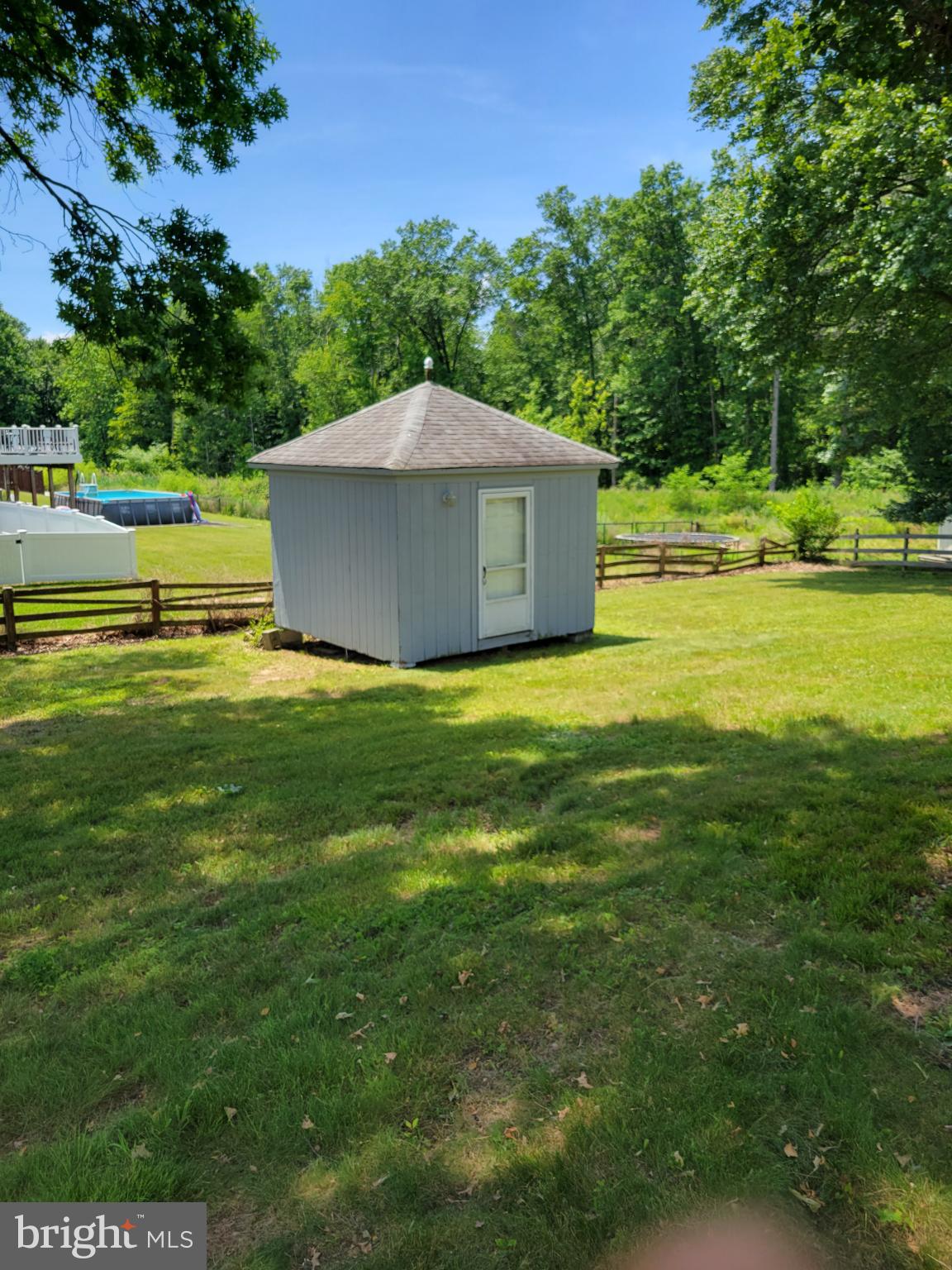 9210 Ravenwood Road Rosedale, MD 21237 - Photo 18 of 18 Charming shed nestled in lush greenery.