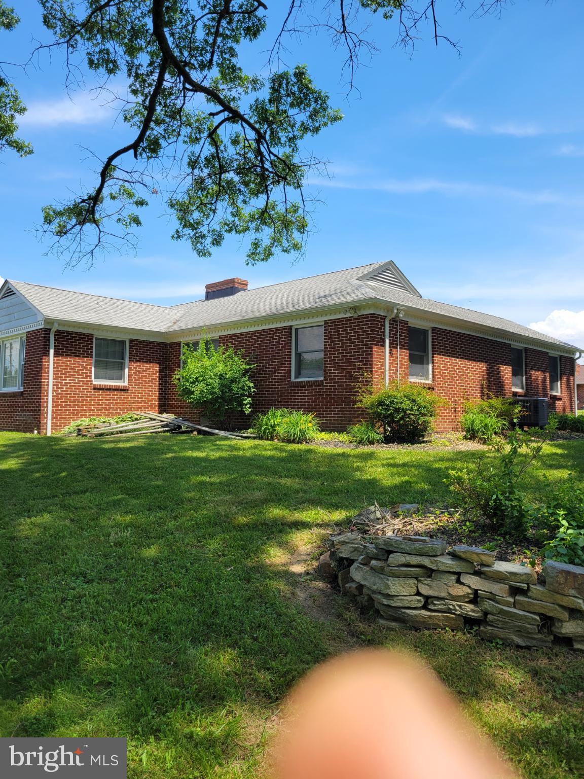 9210 Ravenwood Road Rosedale, MD 21237 - Photo 4 of 18 Charming brick home with lush greenery.