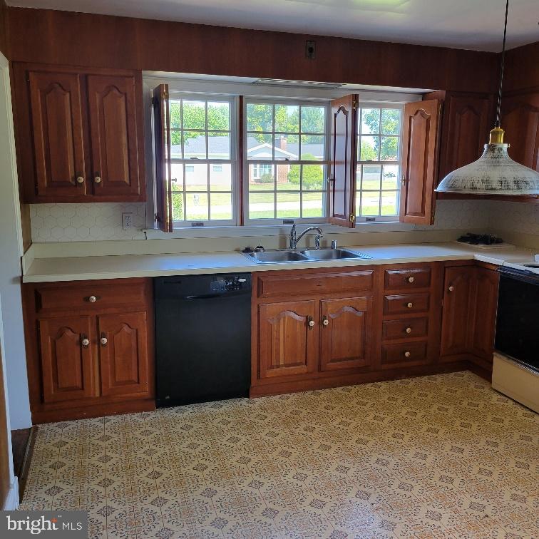 9210 Ravenwood Road Rosedale, MD 21237 - Photo 5 of 18 Bright kitchen with classic wooden cabinetry.