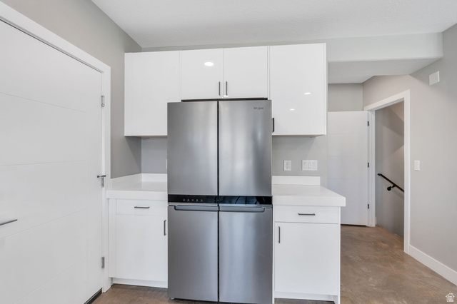 7045 South 300 East Midvale, UT 84047 - Photo 15 of 49 Contemporary kitchen area featuring a stainless steel French door refrigerator, white flat-panel cabinetry, white countertops, and recessed lighting