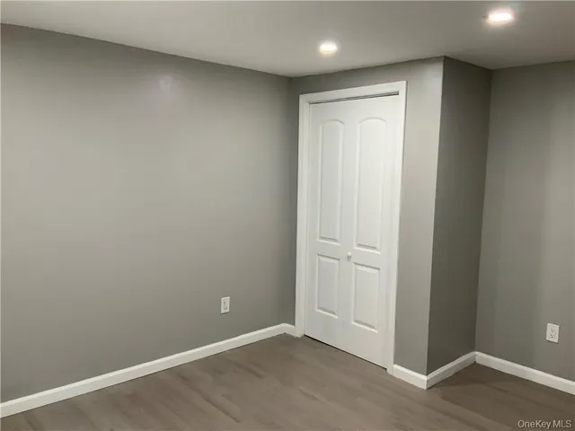 an empty room with wooden floor