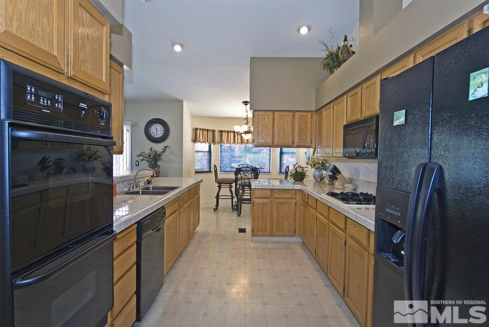 4505 Goodwin Road Sparks, NV 89436 - Photo 15 of 38 a large kitchen with stainless steel appliances granite countertop a stove refrigerator and a sink