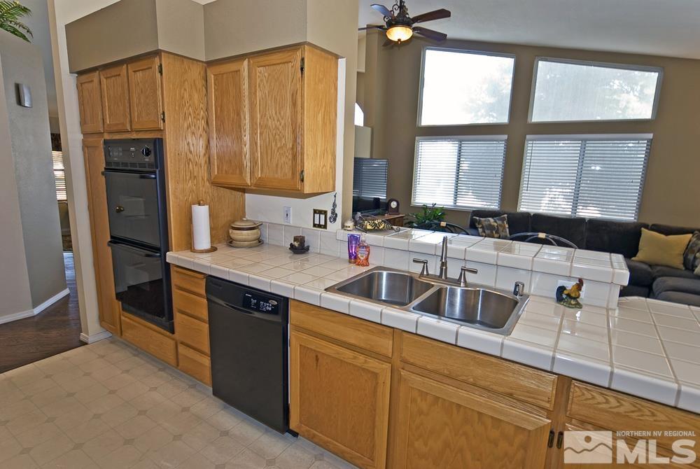 4505 Goodwin Road Sparks, NV 89436 - Photo 16 of 38 a kitchen with stainless steel appliances sink cabinets and window